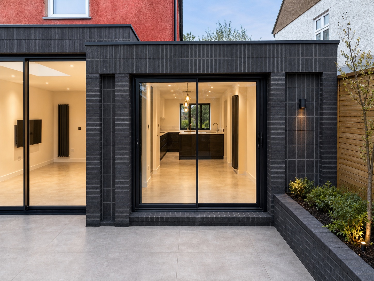 Black aluminium sliding doors on a modern London extension